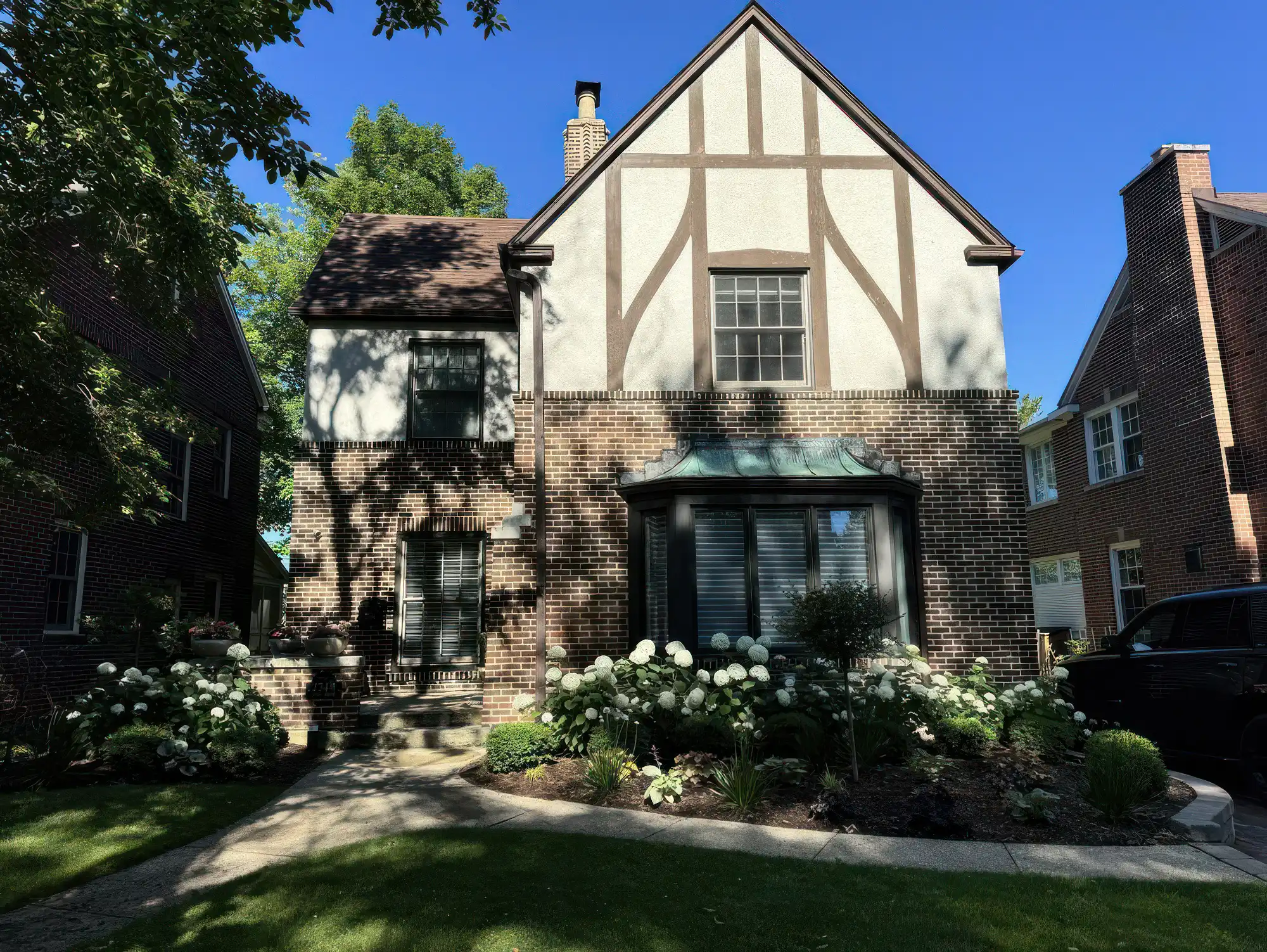 photo of large house with beautiful landscaping / hardscaping